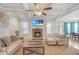 Cozy living room with fireplace, coffered ceilings, and plenty of natural light creates an inviting atmosphere at 4580 Cloister Cir, Hampton, GA 30228