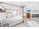 Comfortable main bedroom with a four-poster bed, sitting area, and attached living room at 4580 Cloister Cir, Hampton, GA 30228