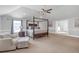 Expansive main bedroom featuring a four-poster bed, sitting area, and access to an en-suite bathroom at 4580 Cloister Cir, Hampton, GA 30228