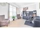 Well-lit home office with large window, built-in shelving, and comfortable seating for remote work at 4580 Cloister Cir, Hampton, GA 30228