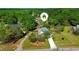 Aerial view of a single-Gathering home with mature trees and landscaping, complemented by a long driveway at 925 Wynn Rd, Mcdonough, GA 30252