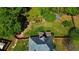 Aerial view showcasing a spacious backyard, wooden deck, lush greenery, and privacy fence at 925 Wynn Rd, Mcdonough, GA 30252