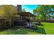 Backyard view featuring a hot tub, wooden deck, and lush greenery, perfect for outdoor relaxation and enjoyment at 925 Wynn Rd, Mcdonough, GA 30252