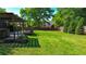 Expansive backyard with lush green grass, wooden fence and a covered deck area at 925 Wynn Rd, Mcdonough, GA 30252