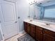 Bathroom featuring a double vanity, ceramic tile floors, and soaking tub in background at 925 Wynn Rd, Mcdonough, GA 30252