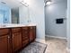 A bathroom featuring a double sink with wood cabinets and a large mirror at 925 Wynn Rd, Mcdonough, GA 30252