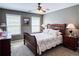 Comfortable bedroom with natural light and neutral walls and a wood bed at 925 Wynn Rd, Mcdonough, GA 30252