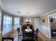 Cozy dining area features a round table, chandelier, and a window offering natural light at 925 Wynn Rd, Mcdonough, GA 30252