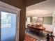 View from the living room to the dining room with a wooden table and decorative lighting at 925 Wynn Rd, Mcdonough, GA 30252