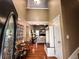 Inviting entryway featuring hardwood floors, a coat rack, and view of the living room beyond at 925 Wynn Rd, Mcdonough, GA 30252