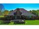 Back exterior view of the brick home and covered deck with hot tub at 925 Wynn Rd, Mcdonough, GA 30252