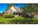 Attractive brick home featuring a cozy front porch, manicured bushes, and a well-kept lawn at 925 Wynn Rd, Mcdonough, GA 30252