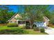 Inviting brick home with a well-manicured lawn, charming front porch, and attached two-car garage at 925 Wynn Rd, Mcdonough, GA 30252