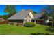 Beautiful brick home with lush green lawn and well-maintained landscaping, showcasing the property's curb appeal at 925 Wynn Rd, Mcdonough, GA 30252