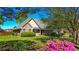 Charming brick home with well-manicured lawn, mature trees, and vibrant pink azaleas in the front yard at 925 Wynn Rd, Mcdonough, GA 30252