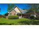 Attractive brick home with well-manicured lawn and mature trees offering a peaceful setting at 925 Wynn Rd, Mcdonough, GA 30252