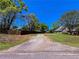 View of the yard and driveway leading up to the home at 925 Wynn Rd, Mcdonough, GA 30252