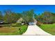 Charming brick home with a long driveway, beautiful lawn, and mature trees adding to the curb appeal at 925 Wynn Rd, Mcdonough, GA 30252