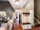 Inviting foyer with coat rack, bench, hardwood floors, and views to the living room and kitchen at 925 Wynn Rd, Mcdonough, GA 30252