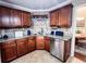 Kitchen area featuring granite countertops, wooden cabinets, stainless steel appliances, and backsplash tiles at 925 Wynn Rd, Mcdonough, GA 30252