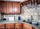 A kitchen featuring granite counters, tile backsplash, and wooden cabinets at 925 Wynn Rd, Mcdonough, GA 30252