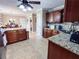Spacious kitchen with views into the dining area and hallways with tile flooring and granite countertops at 925 Wynn Rd, Mcdonough, GA 30252