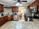 Kitchen with granite countertops, dark wood cabinets, stainless steel appliances, and tile floors at 925 Wynn Rd, Mcdonough, GA 30252