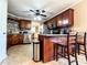 Kitchen with granite countertops, dark wood cabinets, stainless steel appliances, and tile floors at 925 Wynn Rd, Mcdonough, GA 30252