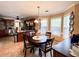 Kitchen dining area featuring granite countertops, wooden cabinets, stainless steel appliances, and backsplash tiles at 925 Wynn Rd, Mcdonough, GA 30252