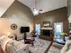 Cozy living room featuring a vaulted ceiling, fireplace, mounted television, and hardwood floors at 925 Wynn Rd, Mcdonough, GA 30252
