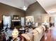 Open-concept living room with hardwood floors, brick fireplace, and views into the dining and kitchen areas at 925 Wynn Rd, Mcdonough, GA 30252