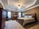 Elegant main bedroom with tray ceiling, neutral carpet, and coordinated furnishings at 925 Wynn Rd, Mcdonough, GA 30252