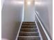 Carpeted staircase with a white handrail ascends to the upper level at 925 Wynn Rd, Mcdonough, GA 30252