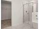 Bright bathroom featuring a shower, tub, and walk in closet at 13580 Whitman Lane, Covington, GA 30014