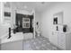 Modern bathroom featuring dual sinks, and a shower/bath with black and white accents at 1430 Fairbanks Sw St, Atlanta, GA 30310