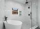 Bathroom featuring luxurious soaking tub, glass enclosed shower and marble accent wall at 1430 Fairbanks Sw St, Atlanta, GA 30310