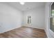 Cozy bedroom with a window, new floors, and a neutral color palette at 1430 Fairbanks Sw St, Atlanta, GA 30310