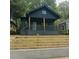 Charming home featuring a stylish front porch, modern railing and well-maintained landscaping at 1430 Fairbanks Sw St, Atlanta, GA 30310