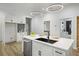 Modern kitchen boasts an island with black sink, quartz counters and stainless appliances at 1430 Fairbanks Sw St, Atlanta, GA 30310