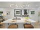 Modern kitchen featuring white cabinets, quartz countertops, backsplash and island seating at 1430 Fairbanks Sw St, Atlanta, GA 30310