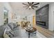 Spacious living room features a modern fireplace and seamless open floor plan to the kitchen and dining at 1430 Fairbanks Sw St, Atlanta, GA 30310