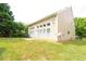 A spacious backyard features lush green grass, complemented by the home's exterior and an array of windows at 2656 Staunton Ln, Duluth, GA 30096