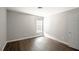 Bedroom featuring hardwood floors, neutral walls, and plenty of natural light at 2656 Staunton Ln, Duluth, GA 30096