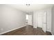 Bedroom featuring hardwood floors, closet, and open door to the hallway at 2656 Staunton Ln, Duluth, GA 30096