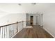 Upstairs hallway featuring hardwood floors and neutral gray walls at 2656 Staunton Ln, Duluth, GA 30096
