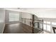 Bright hallway with wood floors, wood railing and staircase, and lots of natural light at 2656 Staunton Ln, Duluth, GA 30096