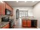 Kitchen with stainless steel appliances, granite countertops, and access to the living room at 2656 Staunton Ln, Duluth, GA 30096
