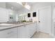 Bright bathroom with dual sinks, stone countertops, modern mirrors, and decorative floral arrangements at 332 Gibson Se St, Atlanta, GA 30316