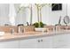Elegant bathroom featuring dual sinks, quartz countertops, modern fixtures, and decorative plants at 332 Gibson Se St, Atlanta, GA 30316