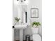 Stylish half bath with modern fixtures, floating sink, framed art and grey stainless steel trash can at 332 Gibson Se St, Atlanta, GA 30316